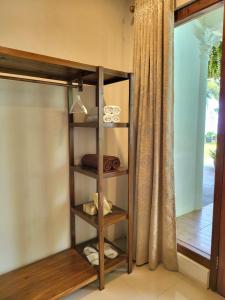 a wooden shelf in a room with a window at Keraton Krakatoa in Banten