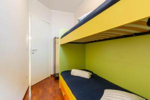 A bed or beds in a room at Appartamento L'Ancora - MyHo Casa