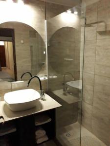a bathroom with a sink and a glass shower at Alquiler en San Rafael in San Rafael