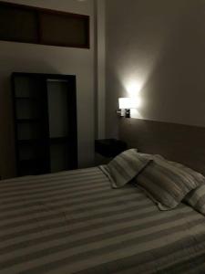 a bedroom with a bed with two pillows on it at Alquiler en San Rafael in San Rafael