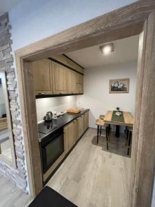 a small kitchen with a table and a counter top at Apartman Anna Budva in Budva