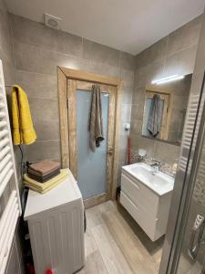 a bathroom with a sink and a toilet and a mirror at Apartman Anna Budva in Budva