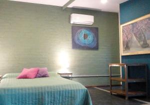 a bedroom with a bed and a air conditioner on the wall at El Atelier - Valle de Uco in La Consulta