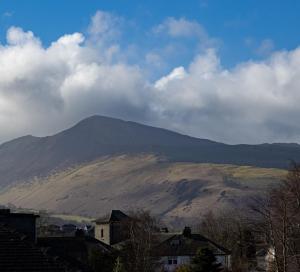 a mountain in the distance with houses and buildings at Loft Apartment, Keswick in Keswick