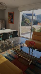 a living room with a table and a couch at Les Logis d Ussé in Rigny-Ussé