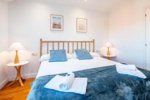 a bedroom with a large bed with towels on it at Villa Bista Eder in Hondarribia +93 photos