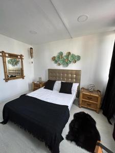 a bedroom with a bed with a black dog laying on the floor at Adeje Luxury Apartment in the south of Tenerife in Adeje