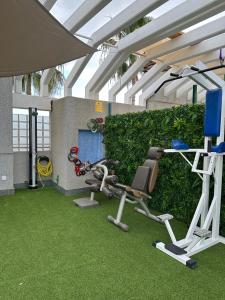 a room with a gym with a bench and a treadmill at Adeje Luxury Apartment in the south of Tenerife in Adeje