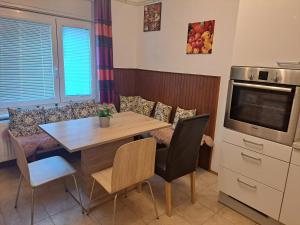 a dining room with a table and a tv at Apartments Prešernova 46 in Bled