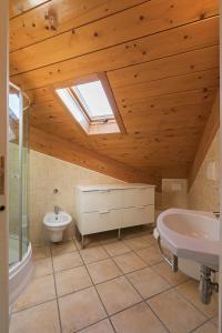 a bathroom with a toilet and a sink and a skylight at Residence Das Nest in Riccione