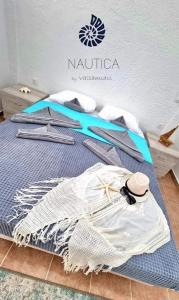a bed with clothes on it in a room at Nautica by Valsamidis in Vlychádia
