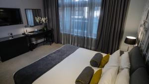 a hotel room with a large bed and a television at Grey Street Hotel in Newcastle upon Tyne
