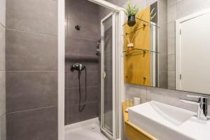 a bathroom with a shower and a sink at Viana Central - Historical City Centre Apartment in Viana do Castelo