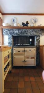 a kitchen with a stove top oven in a kitchen at The Loan in Achiltibuie