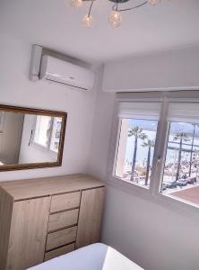 - une chambre avec un miroir, une commode et une fenêtre dans l'établissement Résidence de la mer, à Juan-les-Pins