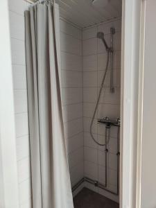 a shower with a white shower curtain in a bathroom at 57 Kauppakatu in Varkaus