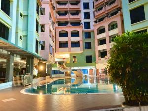 a pool in the middle of a building at Homestay Legacy Kamariah Ahmad,Lumut in Lumut +35 photos
