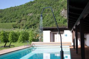a swimming pool with a mountain in the background at Josefsheim in Lana