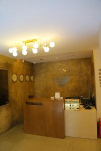 an office with a reception desk and clocks on the wall at Şenyıldız Hotel in İzmir
