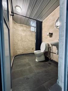 a bathroom with a toilet and a sink at Ardour Lodge "A" Wing in Tanjung Bungah