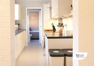 a kitchen with a counter and two stools at Luke Stays - Albert St, Chilton in Chilton