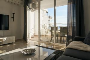 a living room with a couch and a table at The Garrison Apartment in Sarandë