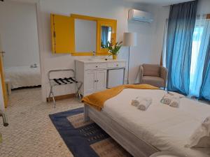 a bedroom with a bed and a sink and a mirror at Quinta Salinas - Puro Prazer in Aveiro