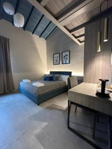 a bedroom with a bed and a table in it at Sogni d'artista in Pietrasanta