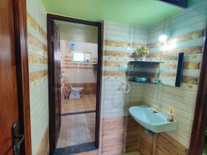 a bathroom with a sink and a toilet in it at luxury home in Vadavalli in Coimbatore