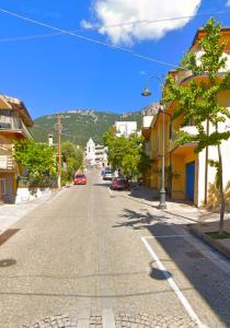 an empty street in a town with a mountain in the background at DOMU IRENE in Triei