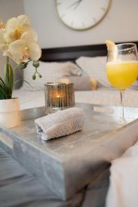 a table with a candle and a glass of orange juice at Cozy airport area hideaway in Philadelphia
