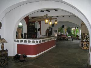 a bar in a restaurant with an archway at Scorpio Villas Resort in Malindi