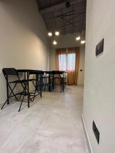 a dining room with black tables and black chairs at Sogni d'artista in Pietrasanta