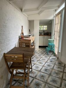 a kitchen with a table and chairs in a room at Fieldside Studio Flat in Hendon