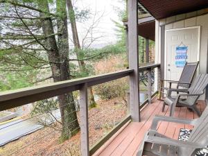 a porch with two chairs on a house at Beech Please Cozy Beech Mountain Stay in Beech Mountain
