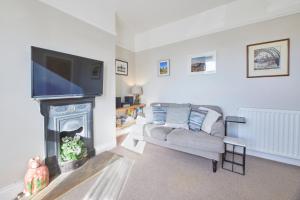 a living room with a couch and a fireplace at Host & Stay - The Cottage in Corbridge in Corbridge