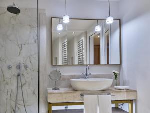 a bathroom with a sink and a mirror at Conrad Chia Laguna Sardinia in Chia