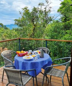 a table with a bowl of fruit on a deck at Cabana Mirim Estalagem Rural in Gramado