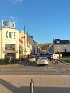 a city street with cars parked in a parking lot at Studio Flat in Largs