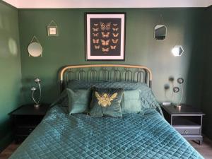 um quarto com uma cama com um edredão azul em No 11, Fishguard, Ideal for beach, coastal path and town! em Fishguard