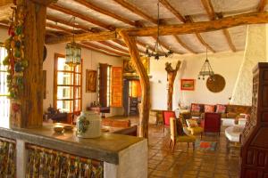 a large living room with wooden ceilings and a living room at Casa de Campo La Escondida in Chincha Baja