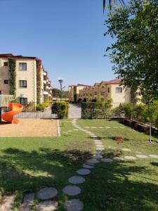 a park with a playground and some buildings at LouieVille One Bedroom Apartment in Lusaka