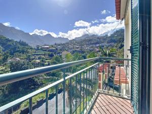 a balcony with a view of a city and mountains at Mountain View Villa by Atlantic Holiday in São Vicente