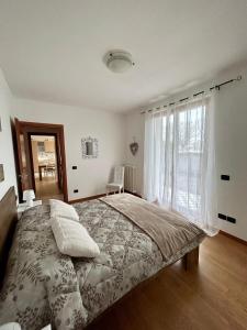 a bedroom with a large bed and a window at Green Room Del Garda in Castelnuovo del Garda