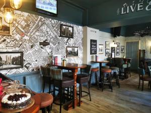 a restaurant with tables and chairs and a wall at The White Horse in York