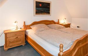 a bedroom with a wooden bed with two night stands at 2 Bedroom Lovely Apartment In Dagebll in Dagebüll
