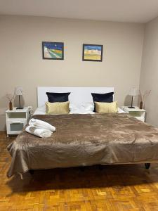 a large bed in a room with two night stands at Somnio Hostels in Barcelona