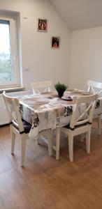a white dining room table and chairs with a table at Ferienwohnung in Stelle bei Familie Thieshen in Stelle