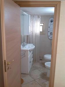 a bathroom with a sink and a toilet at Casa Salento Mare in Torre Ovo