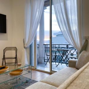 a living room with a couch and a view of a balcony at CROISETTE VUE MER LATERALE in Cannes